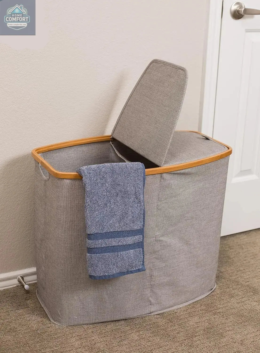 Grey bamboo canvas laundry hamper with lid open and towel hanging showing practical everyday laundry storage use