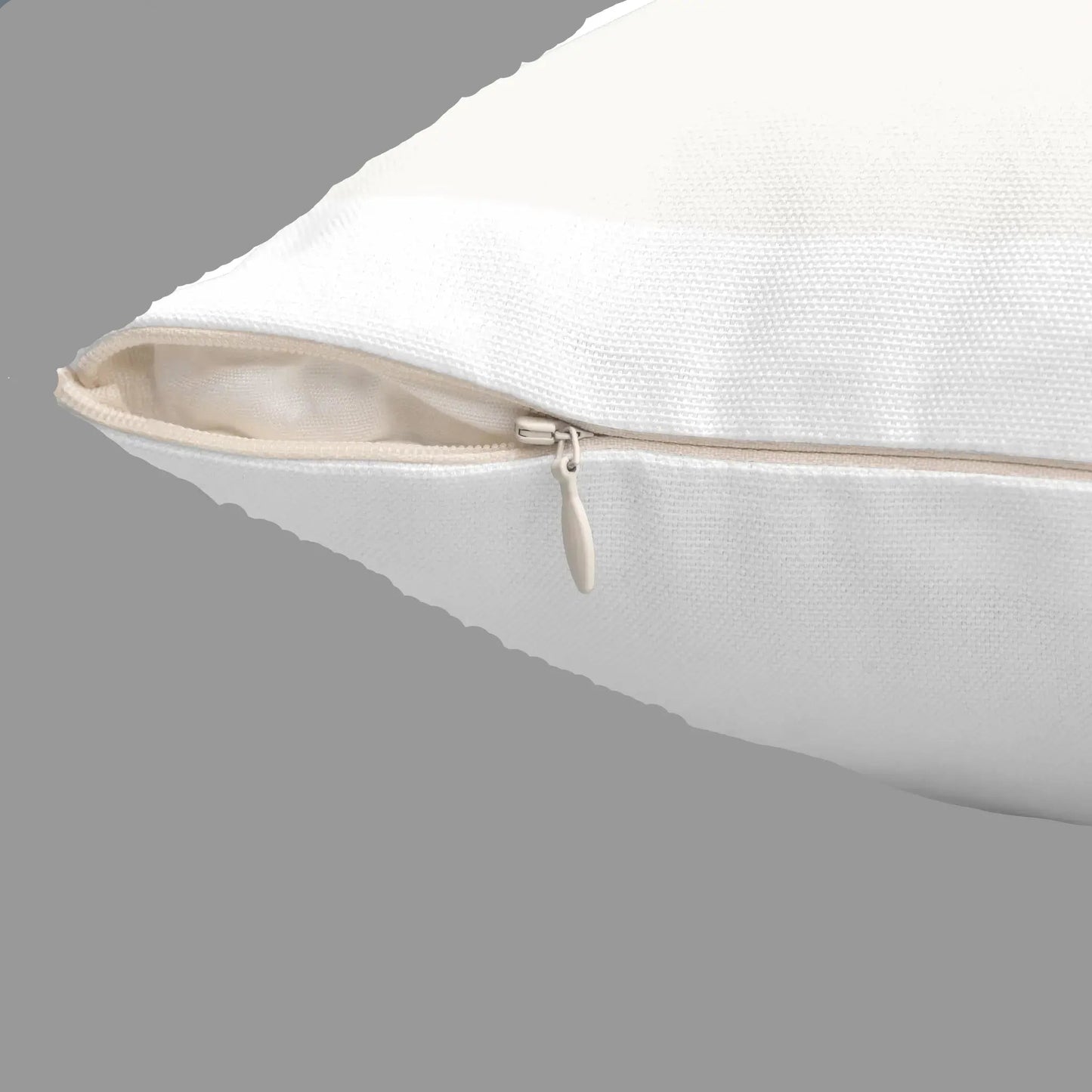 Close-up of hidden zipper on cream square throw pillow showing quality stitching and removable cover