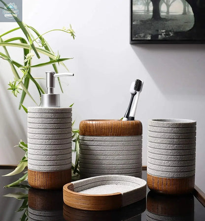Gray ribbed bathroom accessories set with wood accents displayed on bathroom counter with toothbrush holder and soap dispenser
