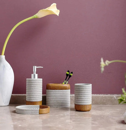 Gray and wood bathroom accessories set with soap dispenser, toothbrush holder, tumbler, and soap dish on bathroom counter