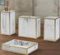 White marble bathroom accessories set with gold trim including soap dispenser, toothbrush holder, tumbler, and soap dish