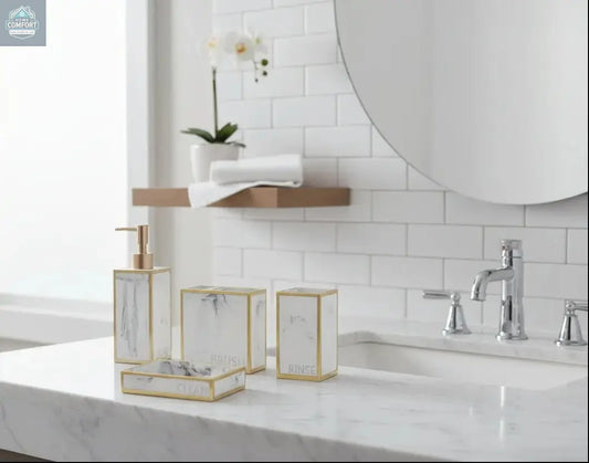 White marble bathroom accessories set with gold trim including soap dispenser, toothbrush holder, tumbler, and soap dish