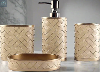 Gold woven bathroom accessories set with soap dispenser, toothbrush holder, tumbler, and soap dish on countertop