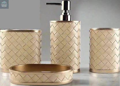 Gold woven bathroom accessories set with soap dispenser, toothbrush holder, tumbler, and soap dish on countertop
