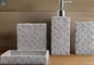 Gray geometric stone bathroom accessories set with soap dispenser, toothbrush holder, tumbler, and soap dish on countertop
