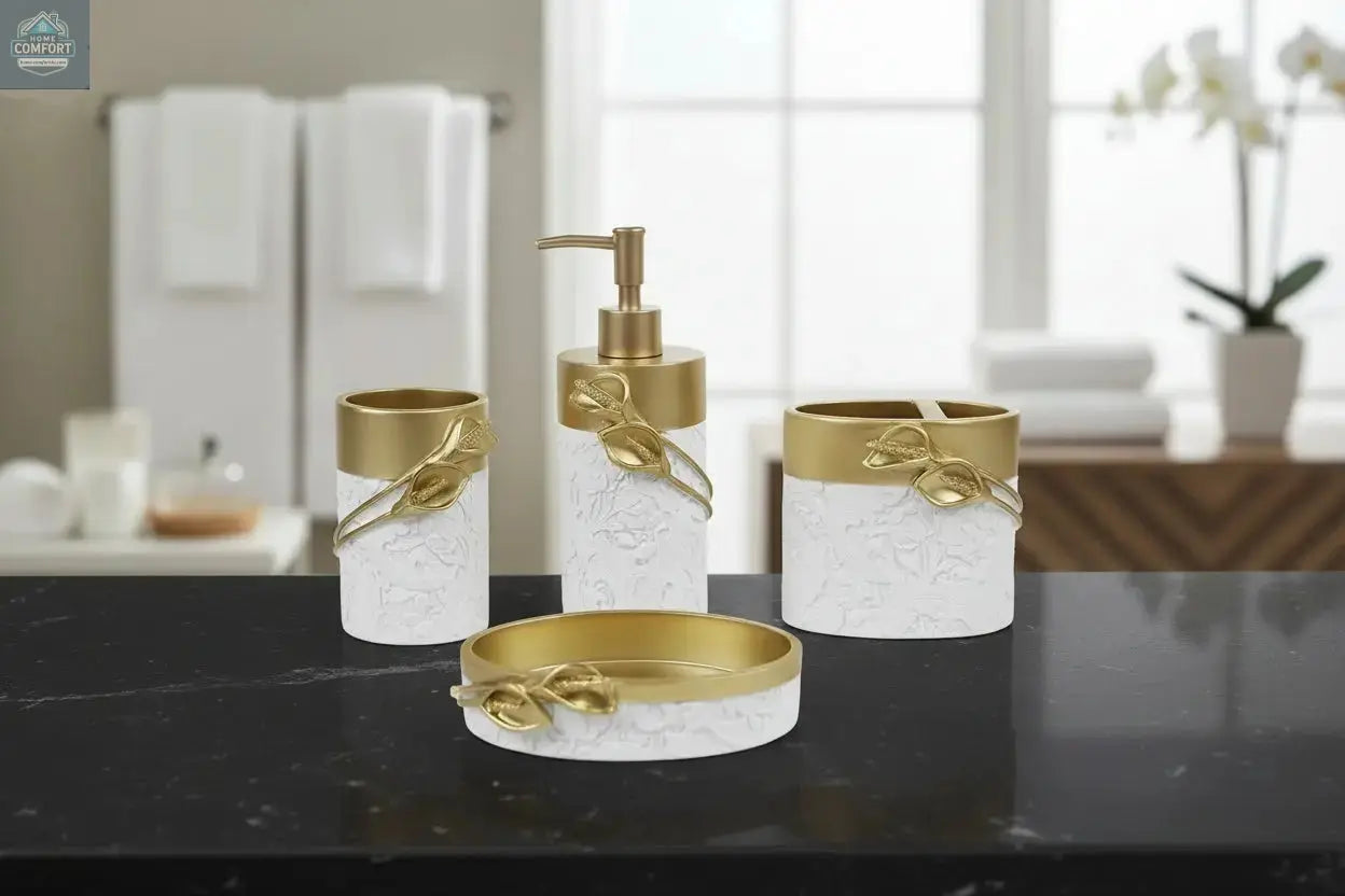 White and gold bathroom accessories set with leaf detail including soap dispenser, toothbrush holder, tumbler, and soap dish