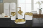 White and gold bathroom accessories set with leaf detail including soap dispenser, toothbrush holder, tumbler, and soap dish