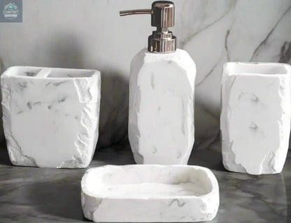 White marble textured bathroom accessories set with soap dispenser, toothbrush holder, tumbler, and soap dish on counter