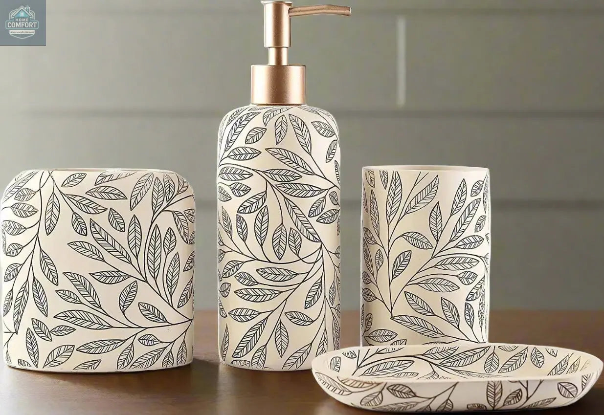 Cream leaf pattern bathroom accessories set with gold pump soap dispenser, tumbler, toothbrush holder, and soap dish