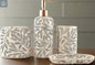 Cream leaf pattern bathroom accessories set with gold pump soap dispenser, tumbler, toothbrush holder, and soap dish