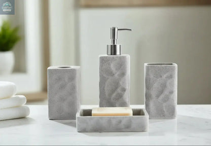 Gray textured stone bathroom accessories set with soap dispenser, toothbrush holder, tumbler, and soap dish on countertop