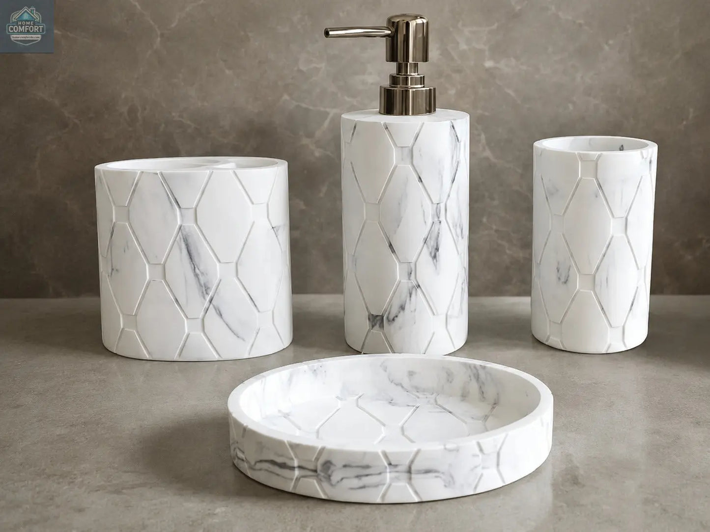 White marble hex pattern bathroom accessories set with soap dispenser, toothbrush holder, tumbler, and soap dish on countertop
