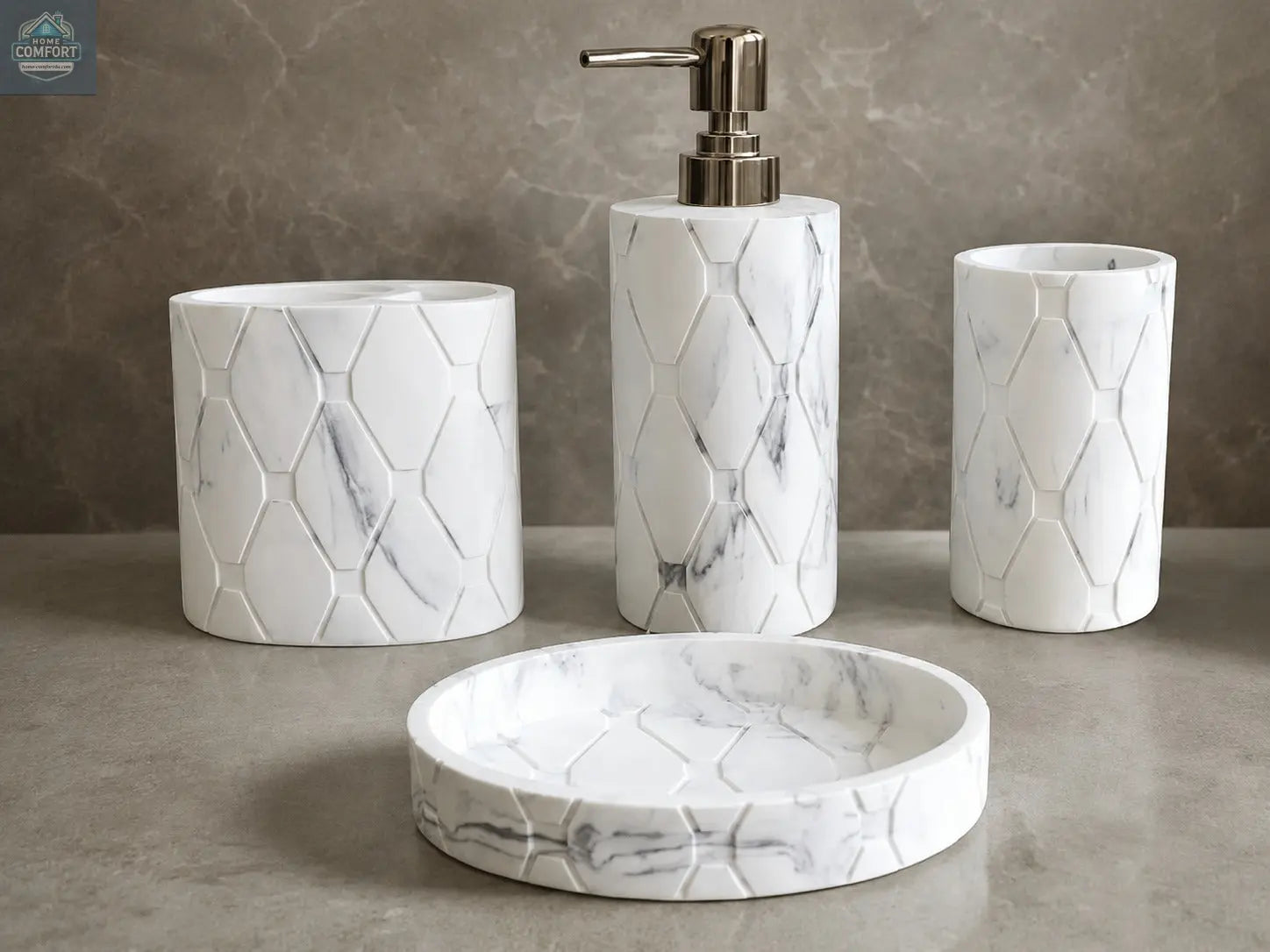 White marble hex pattern bathroom accessories set with soap dispenser, toothbrush holder, tumbler, and soap dish on countertop