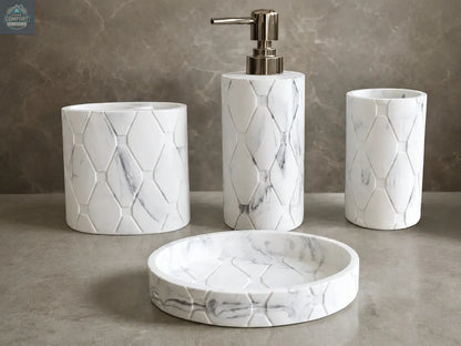 White marble hex pattern bathroom accessories set with soap dispenser, toothbrush holder, tumbler, and soap dish on countertop