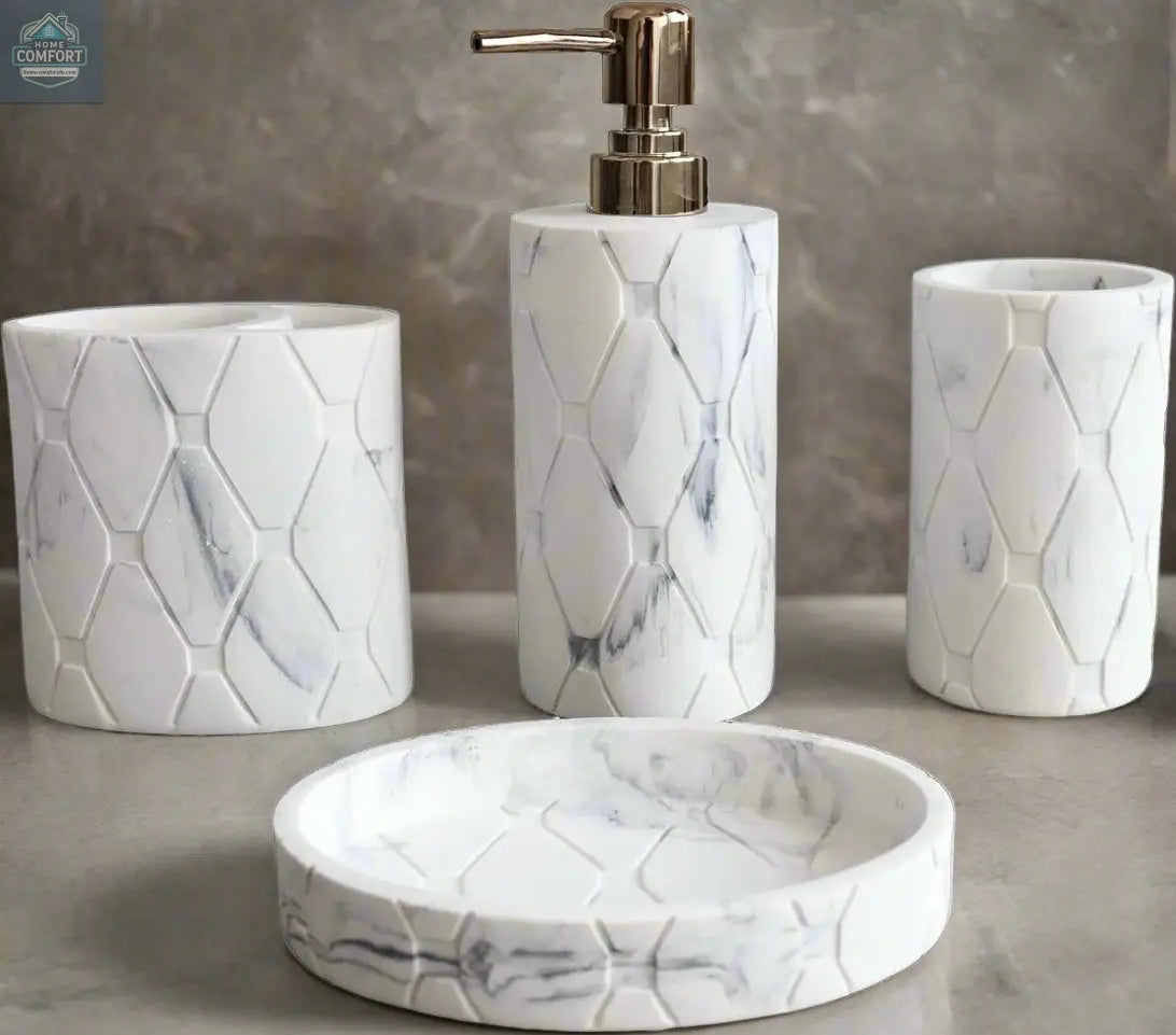 White marble hex pattern bathroom accessories set with soap dispenser, toothbrush holder, tumbler, and soap dish on countertop