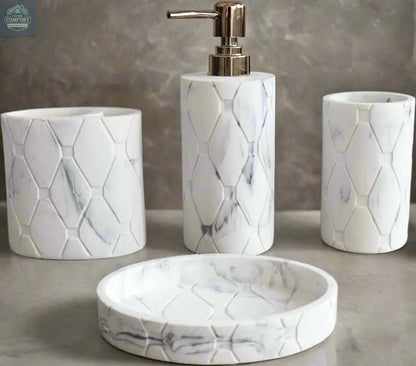 White marble hex pattern bathroom accessories set with soap dispenser, toothbrush holder, tumbler, and soap dish on countertop