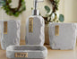 Gray stone bathroom accessories set with soap dispenser, toothbrush holder, tumbler, and tray with labeled pieces on countertop