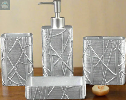 Silver textured bathroom accessories set with soap dispenser, toothbrush holder, tumbler, and soap dish with abstract pattern on countertop