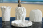 White textured bathroom accessories set with soap dispenser, toothbrush holder, tumbler, and soap dish with coral style surface