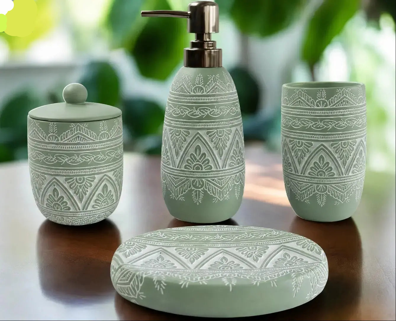 Green patterned bathroom accessories set with soap dispenser, toothbrush holder, tumbler, and soap dish on countertop