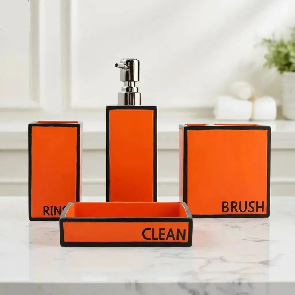 Orange modern bathroom accessories set with soap dispenser, toothbrush holder, tumbler, and soap dish labeled rinse brush and clean