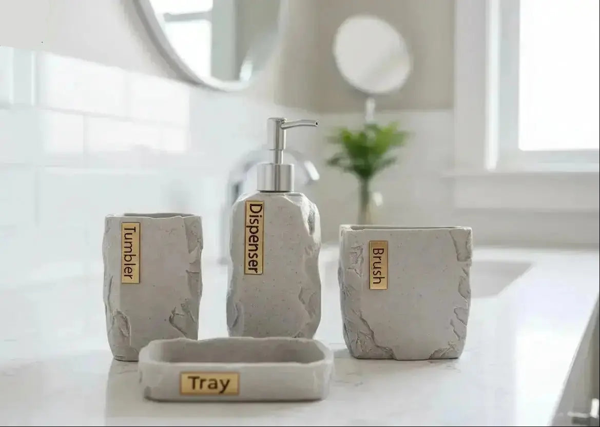 Gray stone bathroom accessories set with soap dispenser, toothbrush holder, tumbler, and tray with labeled pieces on countertop