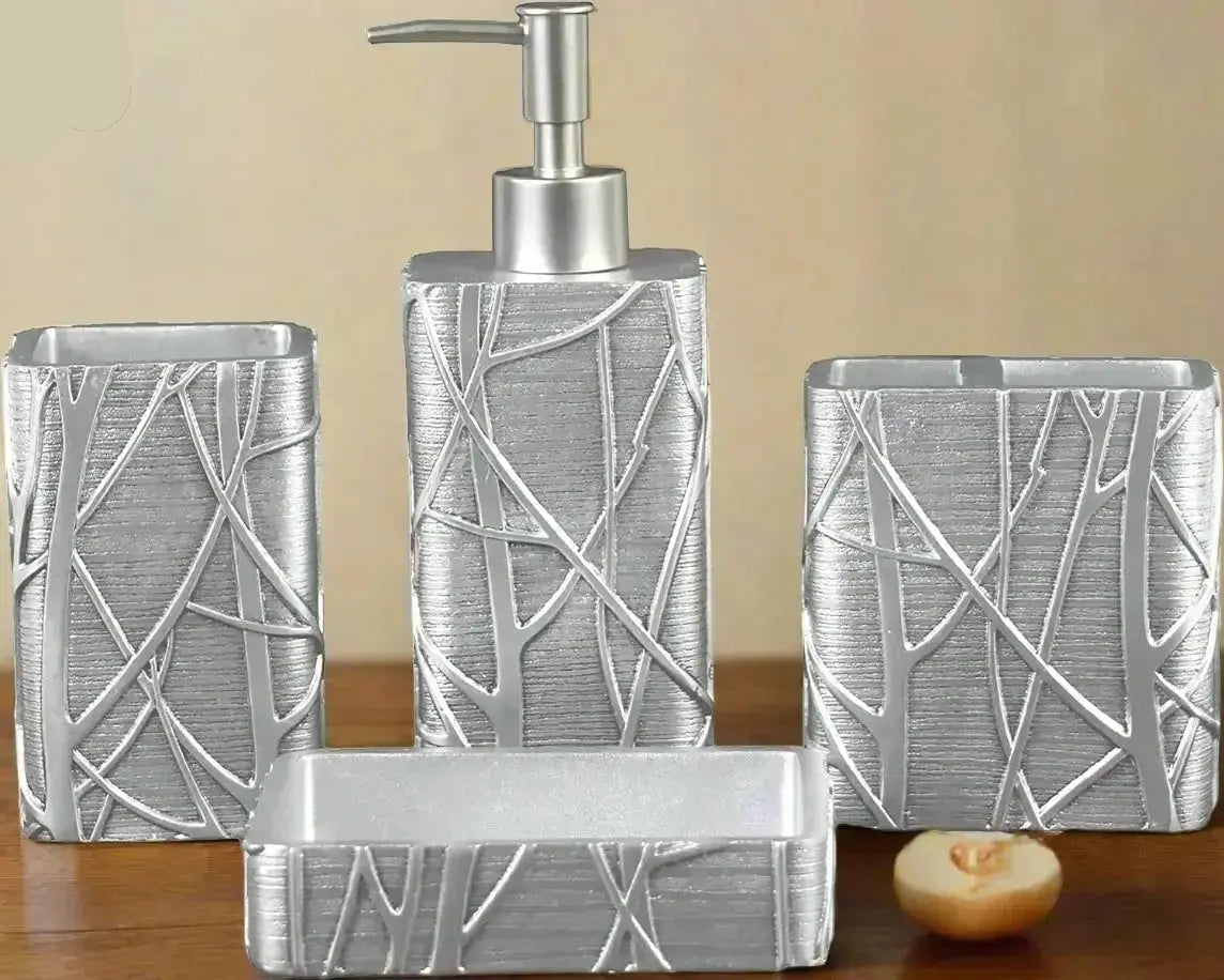 Silver textured bathroom accessories set with soap dispenser, toothbrush holder, tumbler, and soap dish with abstract pattern on countertop