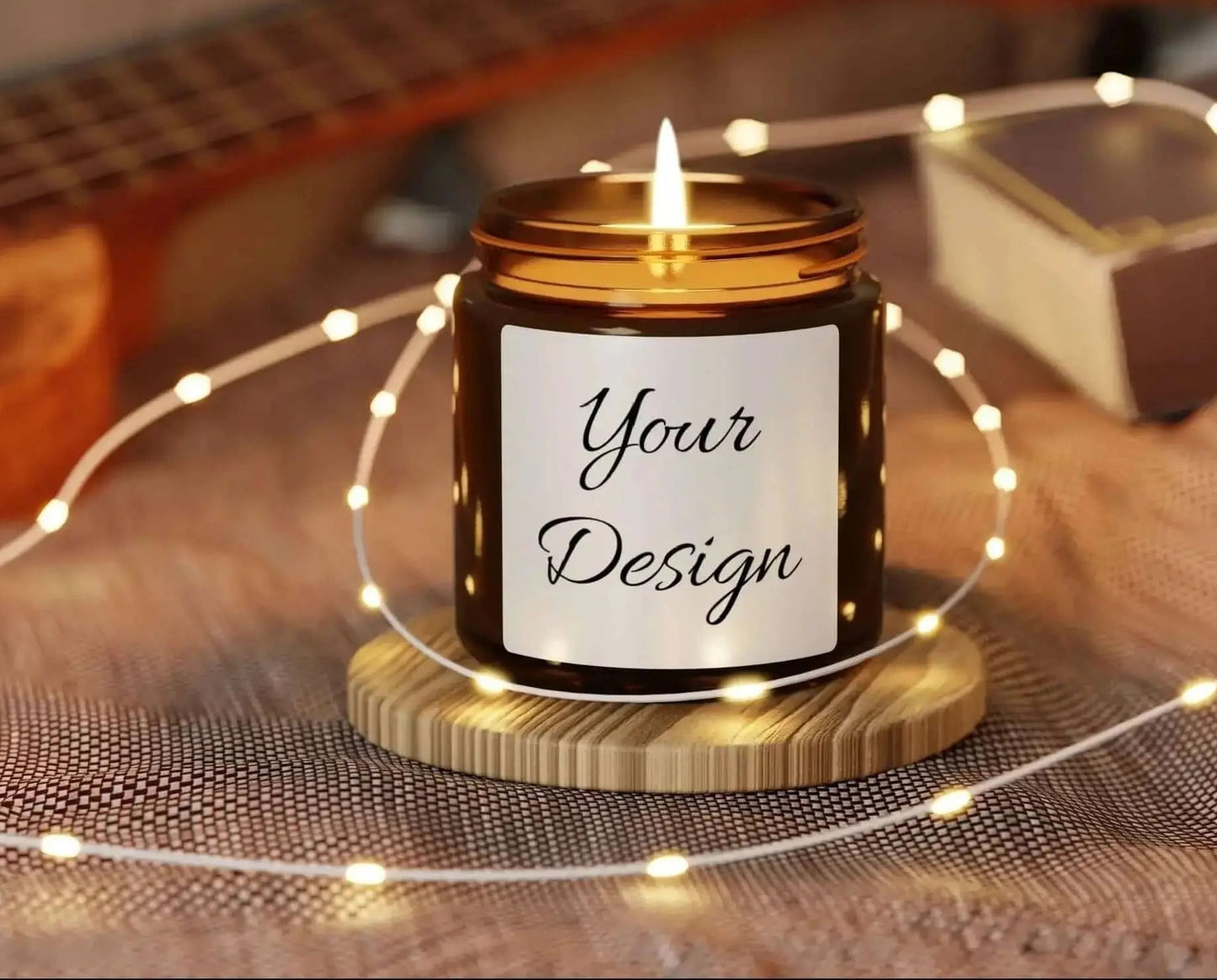 Amber Soy Candle 4 oz in a jar with 'Your Design' label on a wooden coaster surrounded by string lights, with a guitar in the background.