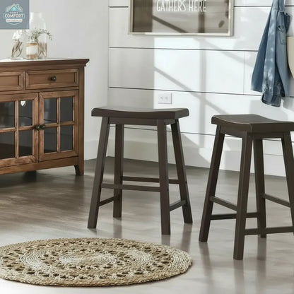 Set of two dark brown wood backless counter stools placed in farmhouse style room