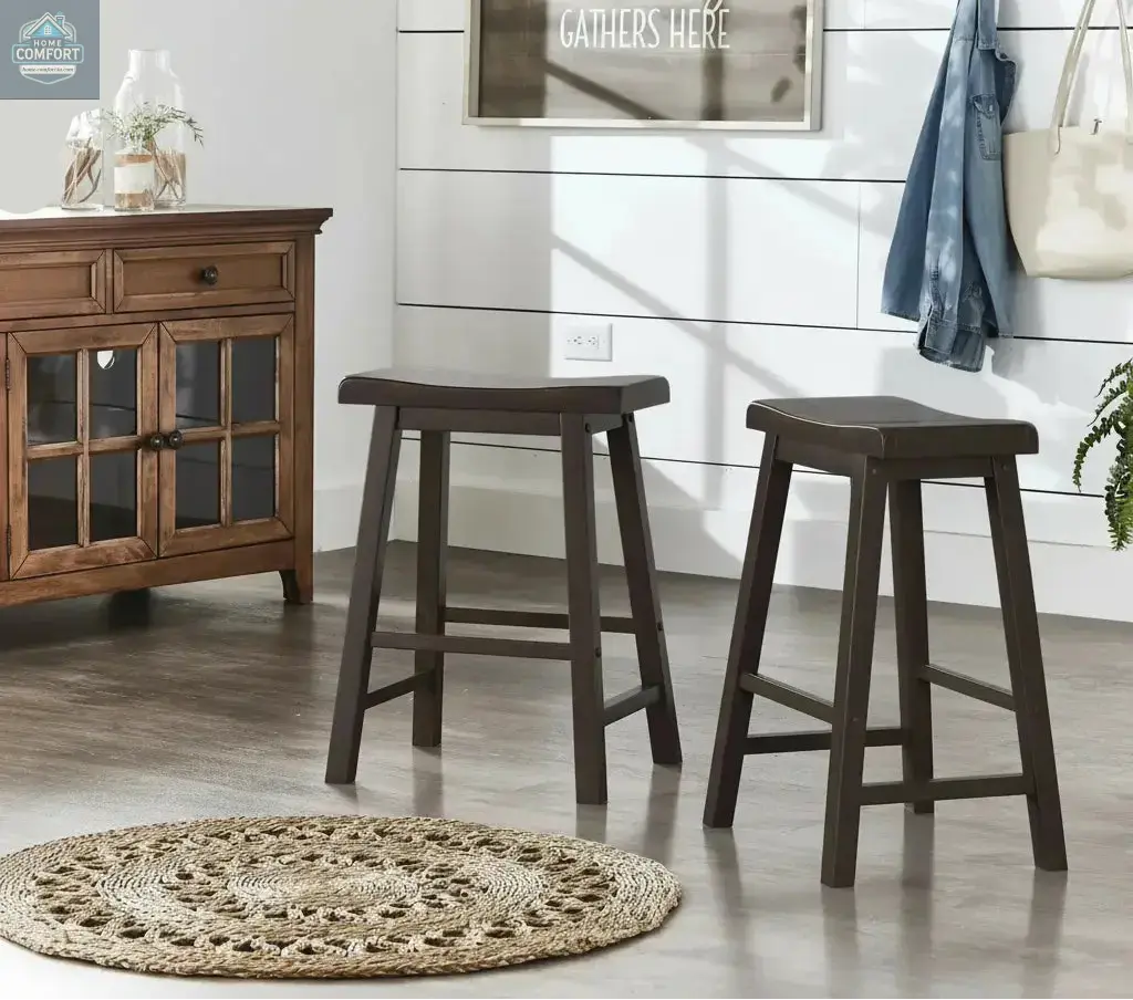 Set of two dark brown wood backless counter stools placed in farmhouse style room