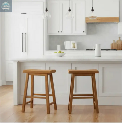 Set of two natural wood saddle seat backless counter stools in indoor room setting