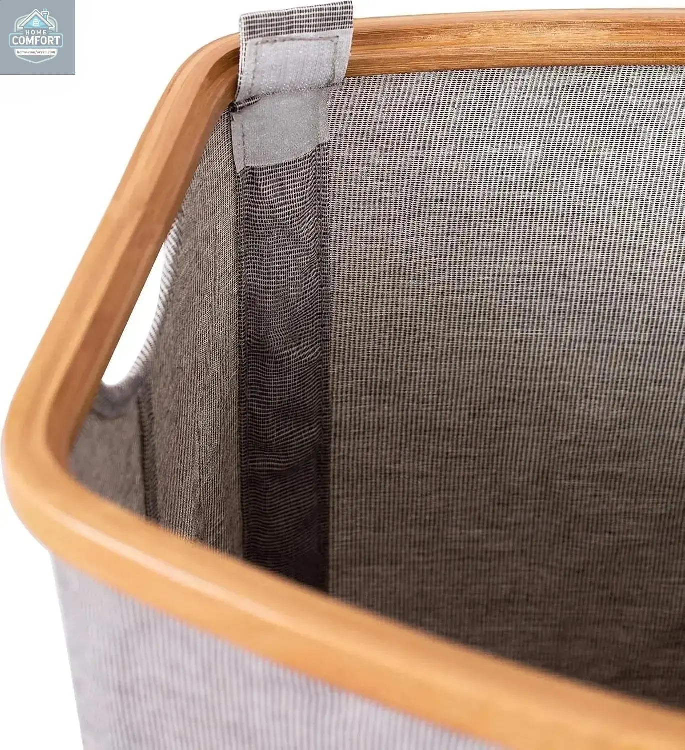 Close up of bamboo frame and grey canvas fabric showing durable construction of modern laundry hamper
