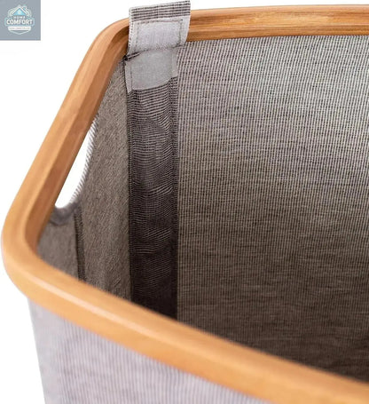 Close up of bamboo frame and grey canvas fabric showing durable construction of modern laundry hamper
