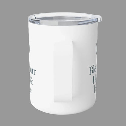 A white insulated travel mug with a clear lid and a side handle, featuring dark gray text on the side, shown on a white background.