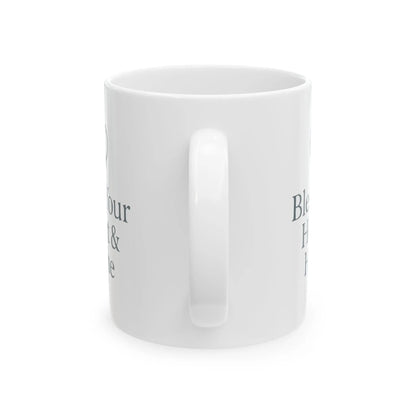 A white ceramic mug with a glossy finish, shown from a side angle on a white background. The mug features dark gray text partially visible on both sides, and a small 'The Comfort Brand' logo is visible in the top-left corner.