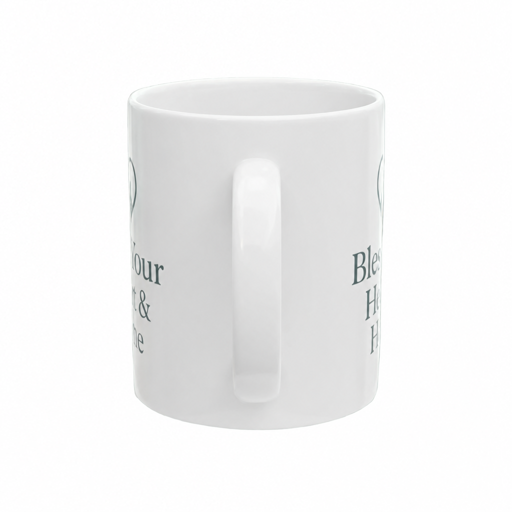 A white ceramic mug with a side handle, featuring partial dark green printed text on the side, shown against a plain white background.
