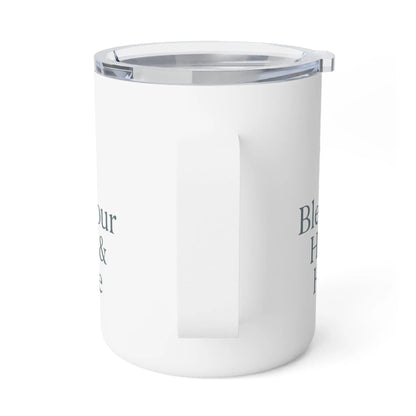 A white insulated travel mug with a clear lid and a side handle, featuring dark gray text on the side, shown on a white background.