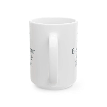 A white ceramic mug with a handle, shown from a side angle on a white background. The mug features dark gray printed text partially visible on both sides.