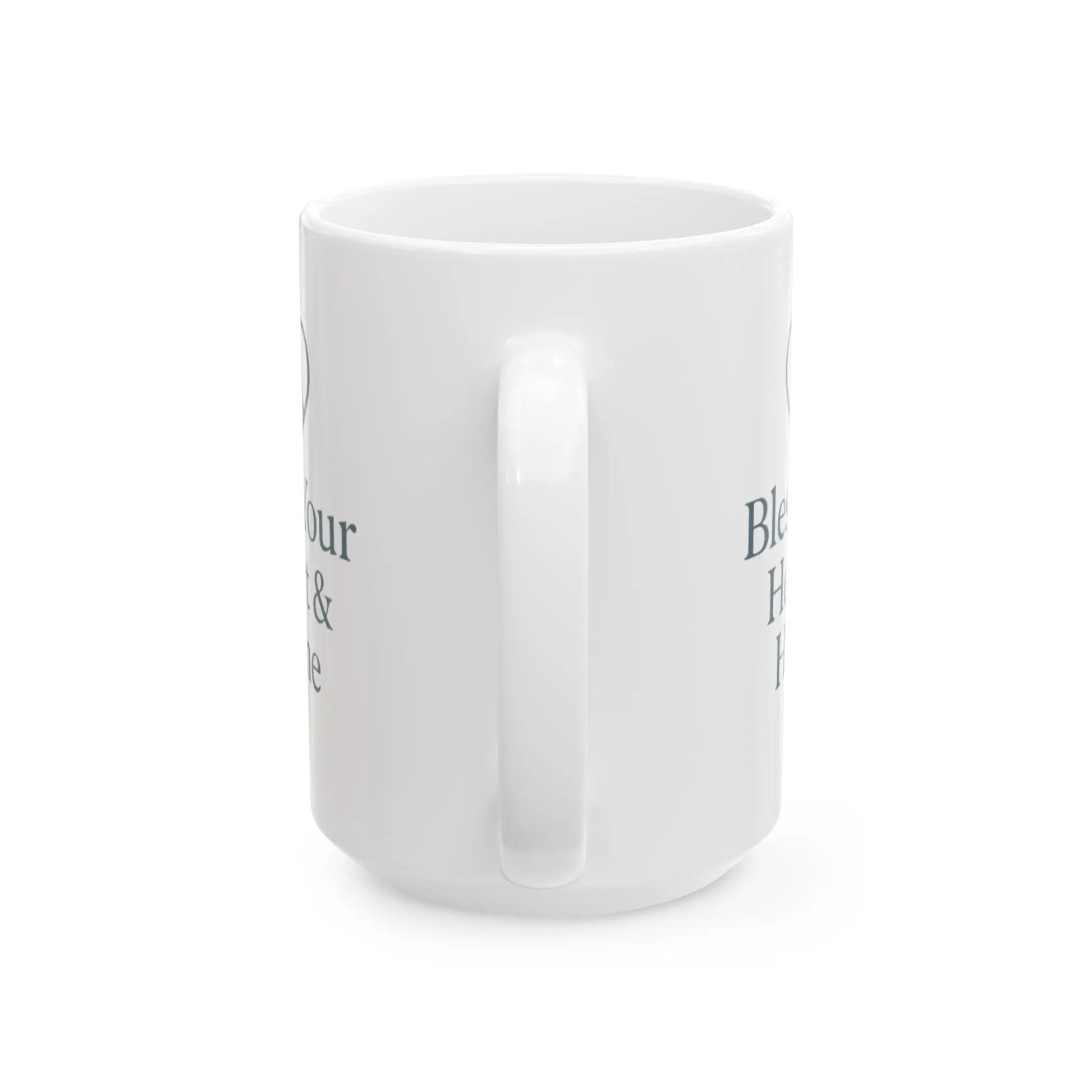 A white ceramic mug with a handle, shown from a side angle on a white background. The mug features dark gray text partially visible on the sides, including the words 'Bless' and 'H.