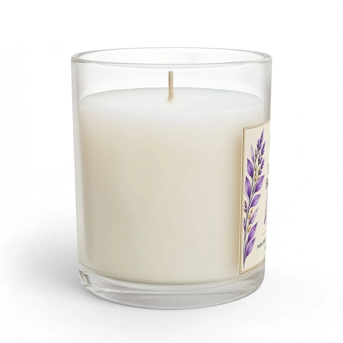 A single-wick candle in a clear glass jar with creamy off-white wax and a side label featuring purple lavender illustrations, shown on a white background.