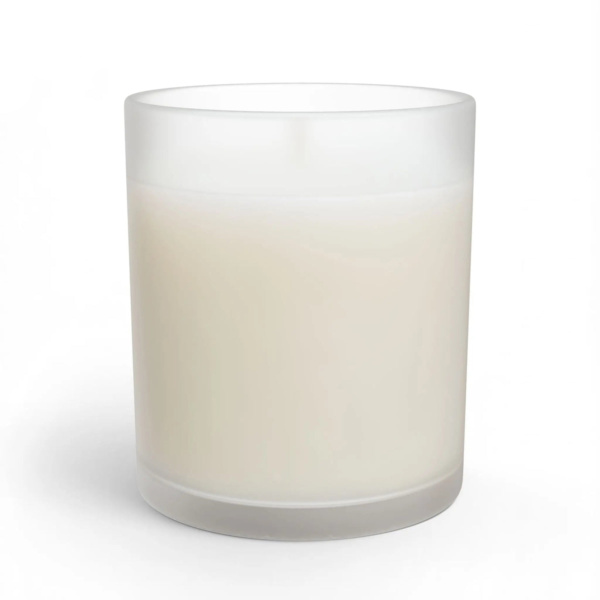 A frosted glass jar candle with creamy off-white wax, shown on a clean white background .