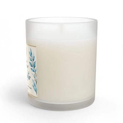 A frosted glass jar candle with creamy off-white wax, featuring a decorative label with blue botanical leaves and gold border details, shown on a clean white background.