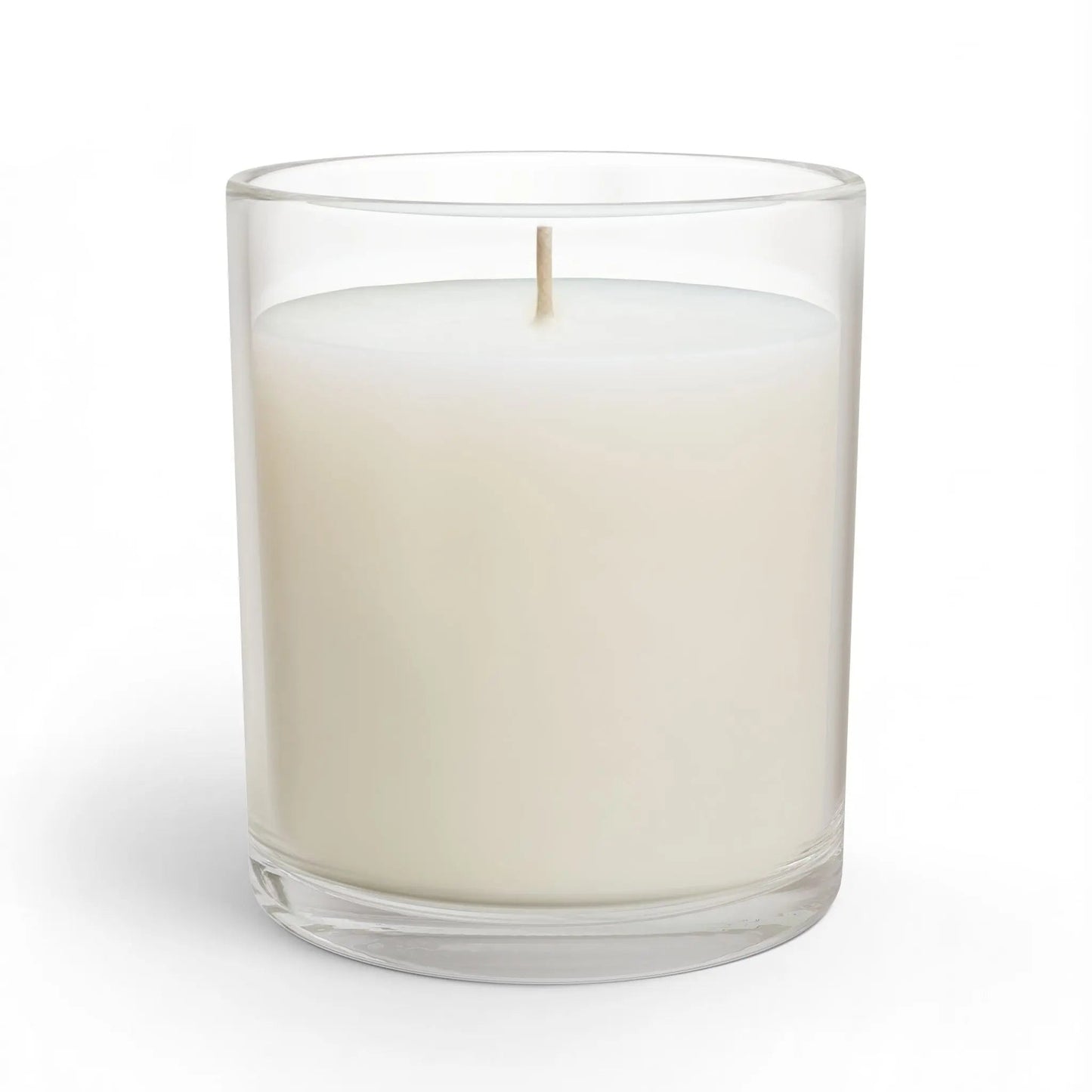White candle in a clear glass container on a white background