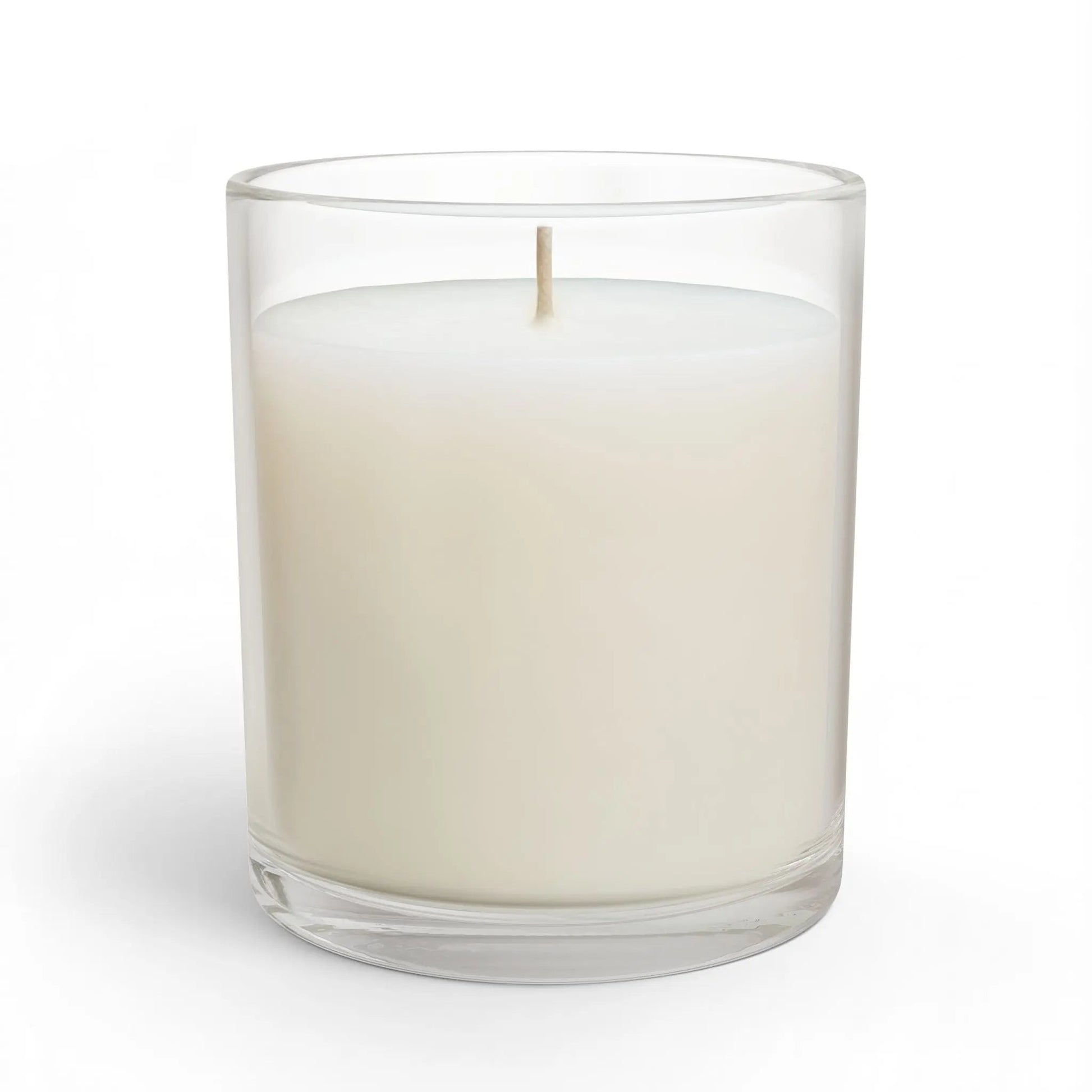 White candle in a clear glass container on a white background