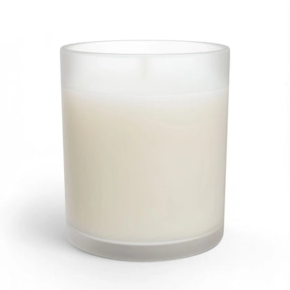 A frosted glass jar candle with creamy off-white wax, shown on a clean white background .
