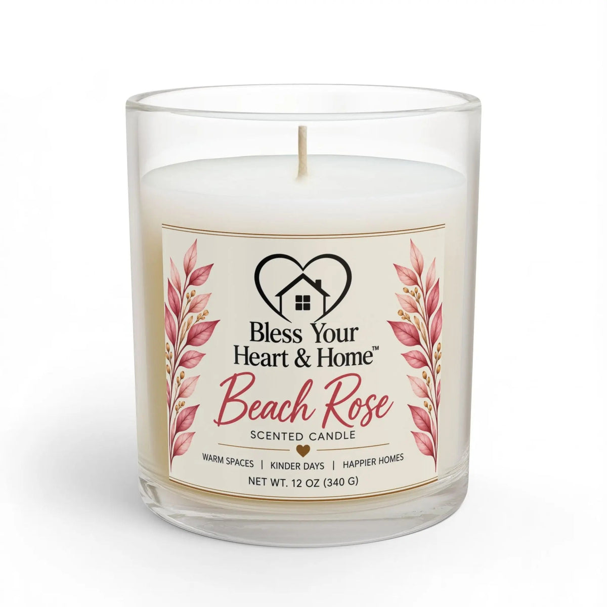 A 11 oz scented candle in a clear glass jar with a white wax fill and a cream-colored label. The label features pink rose illustrations and the brand name 'Bless Your Heart & Home' with the scent name 'Beach Rose'.