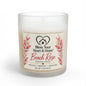 A 11 oz scented candle in a frosted glass jar with a cream-colored wax and a decorative label that reads 'Bless Your Heart & Home Beach Rose'. The label features pink rose illustrations and gold accents, set against a clean white background.