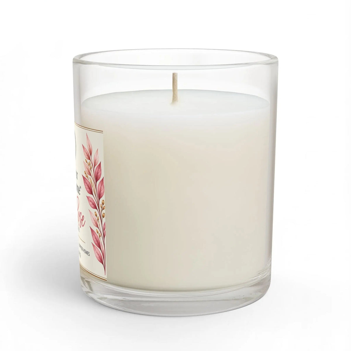 A white wax candle in a clear glass jar with a single wick, featuring a decorative label with pink botanical illustrations. The candle is photographed on a clean white background with a soft shadow.