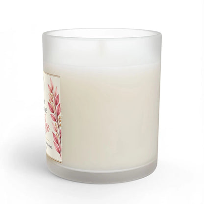 A frosted glass jar candle with creamy off-white wax, featuring a decorative label with pink botanical illustrations on a white background.