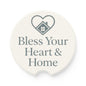 A round white coaster with a gray printed heart and house graphic above the words 'Bless Your Heart & Home'.